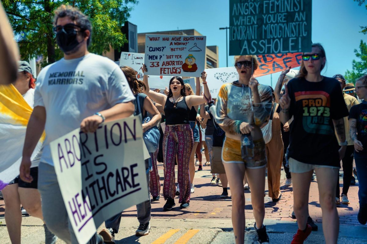 A group of abortion-rights protestors marching holding signs.