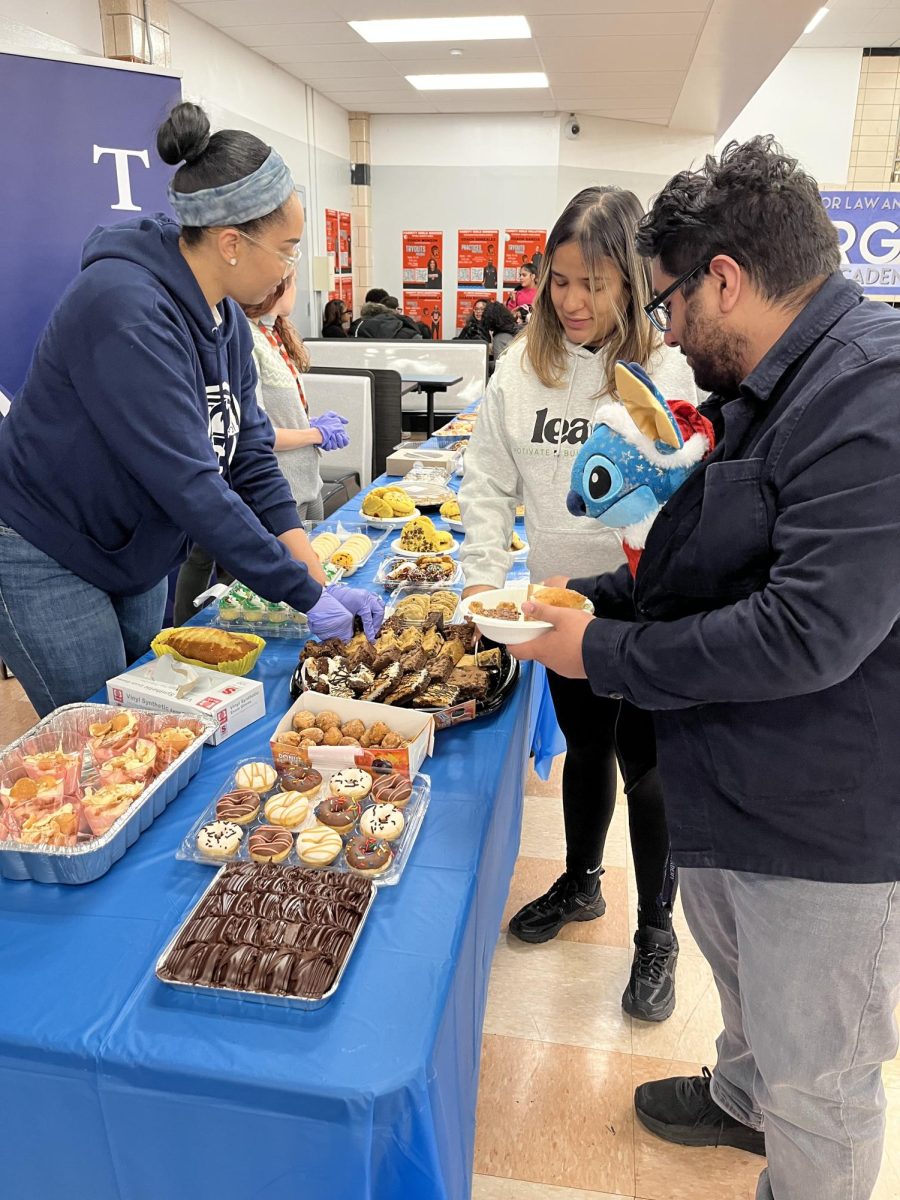 TCA staff (left to right) Ms. Mory-Batista, Ms Melo and Mr. Martinez preparing to serve the students.