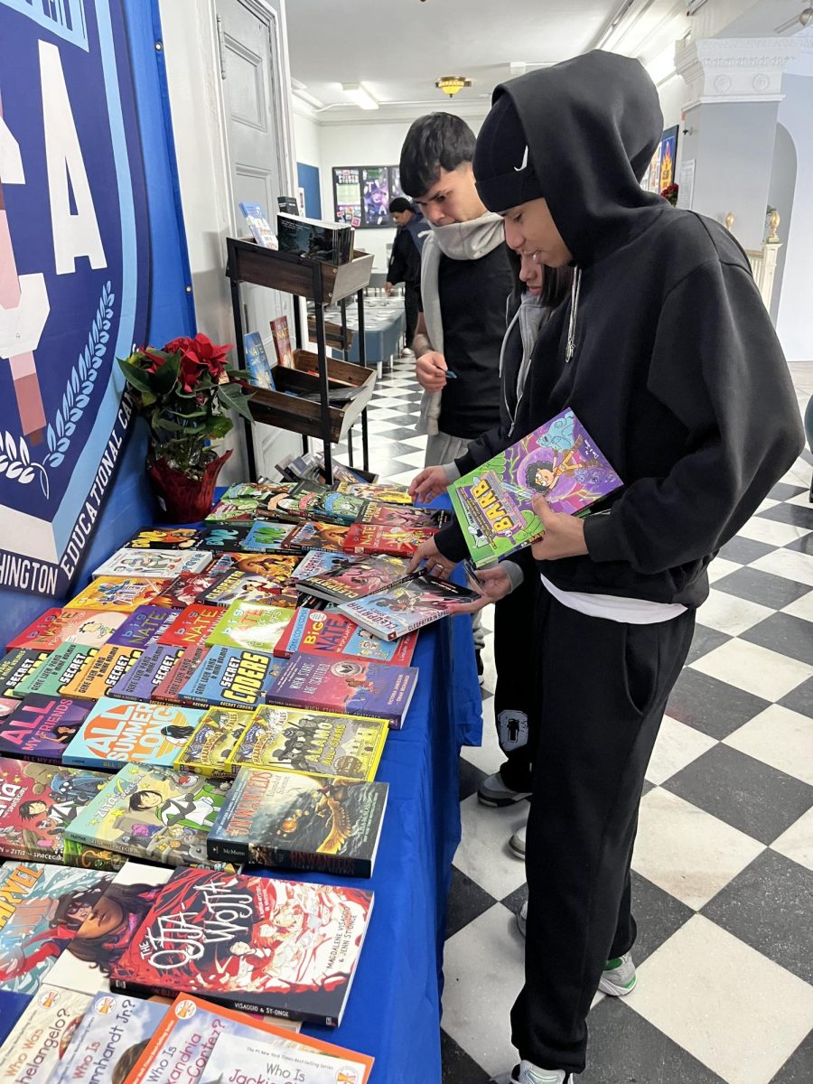 TCA seniors (left to right) Sergio Navarez, Jolenny Mora, Lowesky Soriano selecting books.  