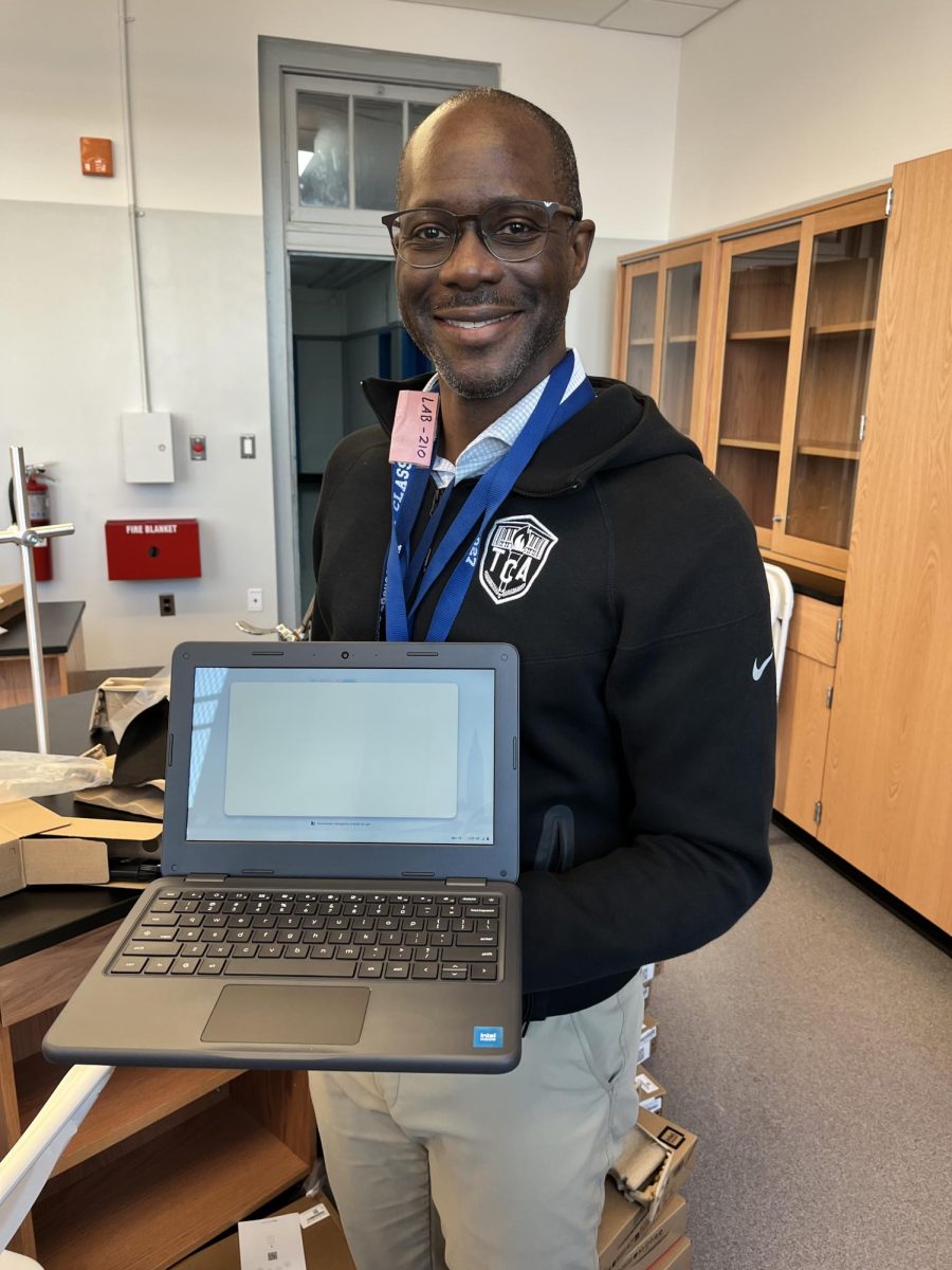 TCA assistant principal Mr. George shows off a new Chromebook.  The new Chromebooks are small yet tough and offer 5G connection.  